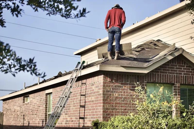 Professional roofer working on a residential roof in Quitnesset